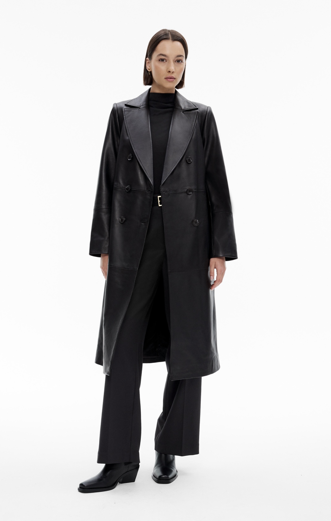 Woman in black leather trench and black pants
