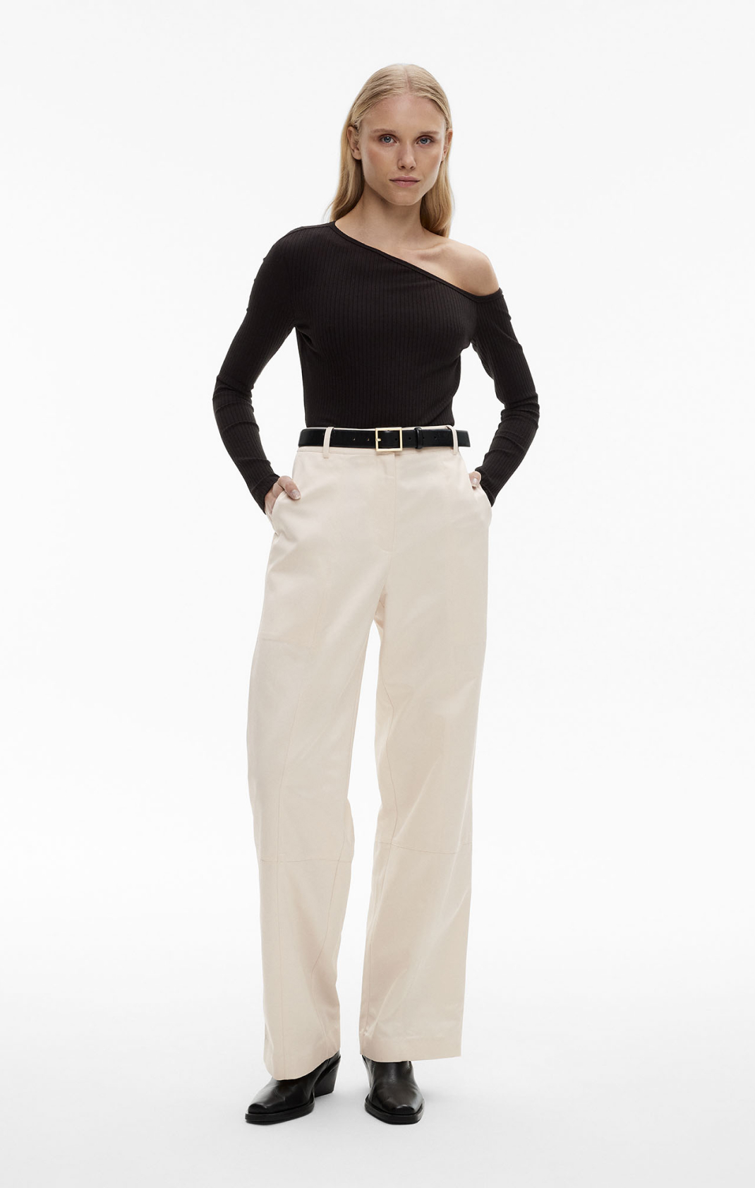 Woman in black knit cardigan and brown midi slip skirt