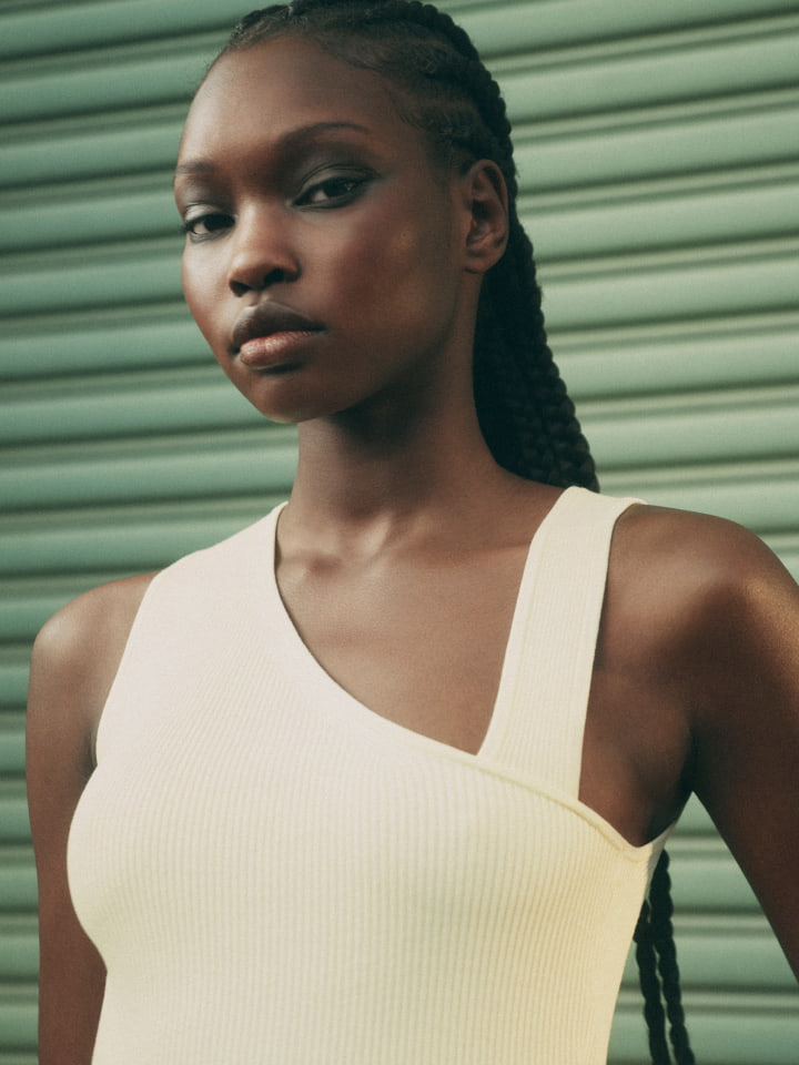 Woman wearing the lemon asymmetric neck rib knit tank