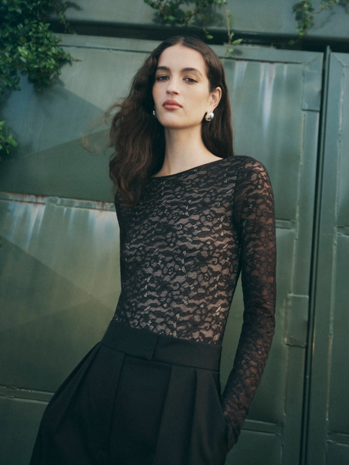 Woman wearing black lace bodysuit, black tailored pant and silver mila large stud earrings