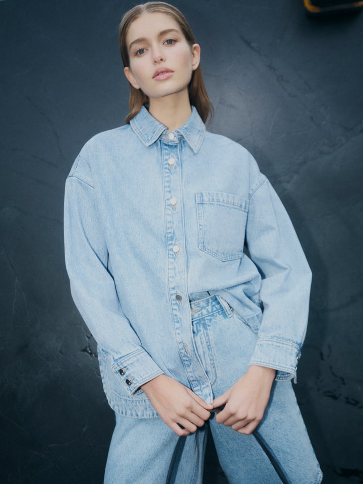 Woman in denim shacket, denim bermuda shorts and black grace mule