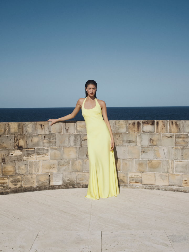 Woman in black halter maxi dress and black heels